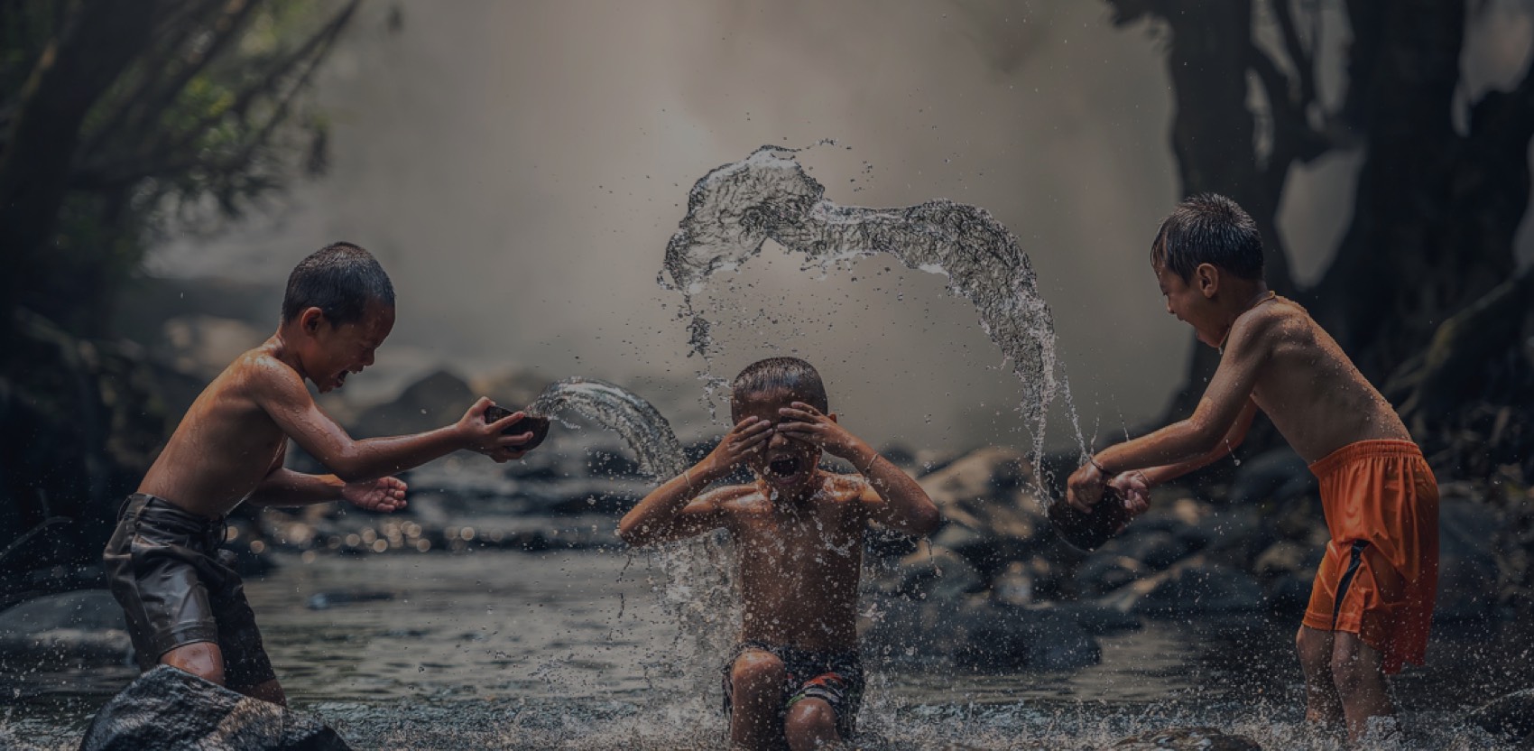 a group of kids playing in water