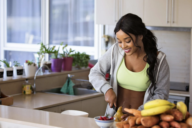 a woman cutting fruits in a kitchen